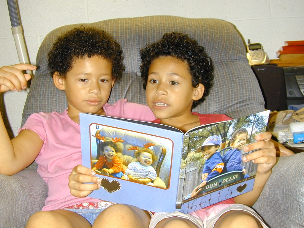 Jordyn reads their storybook to her younger sister, Chloy.